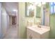 Bathroom with a pristine white vanity and a glimpse of the tiled hallway beyond at 635 Cottage Ln # 635, Lakeland, FL 33803