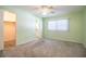 Spacious carpeted bedroom features a ceiling fan, window, and access to a closet and bathroom at 635 Cottage Ln # 635, Lakeland, FL 33803