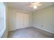 Bedroom featuring plush carpeting, a ceiling fan, and a spacious closet at 635 Cottage Ln # 635, Lakeland, FL 33803