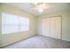 Bedroom featuring plush carpeting, a ceiling fan, and a spacious closet at 635 Cottage Ln # 635, Lakeland, FL 33803