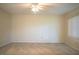 Neutral bedroom featuring carpet, ceiling fan, and window letting in natural light at 635 Cottage Ln # 635, Lakeland, FL 33803