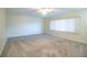 Spacious bedroom has a ceiling fan and a large window that illuminates the carpeted flooring at 635 Cottage Ln # 635, Lakeland, FL 33803