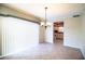 A dining area featuring an elegant chandelier and tile flooring connects to the kitchen at 635 Cottage Ln # 635, Lakeland, FL 33803