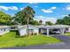 Beautifully maintained home with a convenient carport, lush lawn and mature landscaping at 635 Cottage Ln # 635, Lakeland, FL 33803