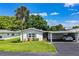 Well-kept home featuring a convenient carport and manicured lawn with landscaping at 635 Cottage Ln # 635, Lakeland, FL 33803
