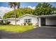 Charming single-story home boasts a carport, well-maintained lawn and verdant landscaping at 635 Cottage Ln # 635, Lakeland, FL 33803