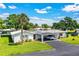 Charming home with a convenient carport, well-manicured lawn and tropical landscaping at 635 Cottage Ln # 635, Lakeland, FL 33803