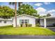 Cozy home with a lush green lawn, quaint landscaping, and a convenient covered carport at 635 Cottage Ln # 635, Lakeland, FL 33803