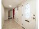Inviting hallway features neutral tile flooring, ample lighting, and a glimpse of rooms beyond at 635 Cottage Ln # 635, Lakeland, FL 33803