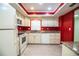 Bright kitchen with white appliances, granite countertops, and red accent wall at 635 Cottage Ln # 635, Lakeland, FL 33803
