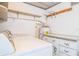 Cozy laundry room featuring a washer, dryer, water heater, shelving, and storage cabinets at 635 Cottage Ln # 635, Lakeland, FL 33803