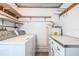 Functional laundry room featuring a washer, dryer, shelving, and storage cabinet at 635 Cottage Ln # 635, Lakeland, FL 33803