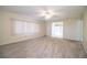 Inviting living room with neutral walls, carpeting, and natural light from the window and adjoining room at 635 Cottage Ln # 635, Lakeland, FL 33803