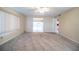 Light-filled living room with carpeting and views to dining area and kitchen at 635 Cottage Ln # 635, Lakeland, FL 33803