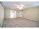 Bright living room with carpeted floor offers seamless transition to dining and kitchen areas at 635 Cottage Ln # 635, Lakeland, FL 33803