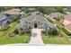 An aerial view showing the home's green roof, mature landscaping, and brick driveway at 715 Hanover Ct, Lakeland, FL 33813