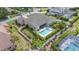 Aerial view of the backyard featuring a refreshing pool and spa, framed by a white fence and greenery at 715 Hanover Ct, Lakeland, FL 33813