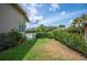 Well-maintained backyard featuring a landscaped lawn, manicured hedges, and a private outdoor retreat at 715 Hanover Ct, Lakeland, FL 33813
