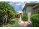 Landscaped backyard with stepping stones, mature trees, and lush greenery creating a private outdoor space at 715 Hanover Ct, Lakeland, FL 33813