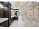 A luxurious bathroom featuring dual vanities, marble countertops, and a glass shower at 715 Hanover Ct, Lakeland, FL 33813
