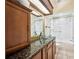 Bathroom with glass vessel sink, granite countertop, and a tiled shower with glass doors at 715 Hanover Ct, Lakeland, FL 33813