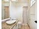 Bathroom featuring a granite countertop, modern sink, and a glass-enclosed shower at 715 Hanover Ct, Lakeland, FL 33813