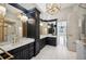 Lavish bathroom featuring dual vanities, marble countertops, gold accents, and natural light at 715 Hanover Ct, Lakeland, FL 33813