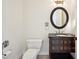 Well-lit half bathroom with a dark vanity and ornate fixtures at 715 Hanover Ct, Lakeland, FL 33813