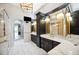 Luxurious Primary bathroom with dual vanities, marble countertops, and decorative lighting at 715 Hanover Ct, Lakeland, FL 33813