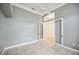 A bedroom with tile floor, light grey walls, crown molding, and french doors to another room at 715 Hanover Ct, Lakeland, FL 33813