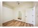 Bedroom with wood-look floors, ceiling fan, neutral paint, and doorway to adjacent room at 715 Hanover Ct, Lakeland, FL 33813