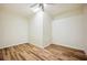 Bright bedroom featuring wood-look flooring, a ceiling fan, neutral walls, and ample natural light at 715 Hanover Ct, Lakeland, FL 33813