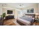 Stylishly furnished bedroom featuring wood-look floors, and a large window at 715 Hanover Ct, Lakeland, FL 33813