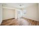 Bedroom with wood-look flooring, ceiling fan, large window, and doorway to closet at 715 Hanover Ct, Lakeland, FL 33813