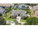 Beautiful home featuring a large driveway, arched entryway, and tropical landscaping with palm trees in a well-maintained community at 715 Hanover Ct, Lakeland, FL 33813