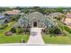 Aerial view of a well-maintained home featuring lush landscaping, a circular driveway, and a stately entrance at 715 Hanover Ct, Lakeland, FL 33813