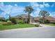 Charming single-story home boasting a well-manicured lawn, brick driveway, and mature palm trees enhancing curb appeal at 715 Hanover Ct, Lakeland, FL 33813