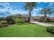 Inviting single-story residence with lush green lawn and mature landscaping, creating a serene and picturesque setting at 715 Hanover Ct, Lakeland, FL 33813