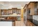 Featuring granite countertops, custom wood cabinetry, and stainless appliances in this gourmet kitchen at 715 Hanover Ct, Lakeland, FL 33813