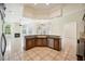 Open floorplan kitchen with bar seating and a sink, stainless appliances and views into the living room at 715 Hanover Ct, Lakeland, FL 33813