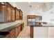 Expansive kitchen with stainless appliances, island, granite countertops, and custom wood cabinets at 715 Hanover Ct, Lakeland, FL 33813