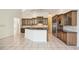 Large kitchen with island seating, stainless appliances, plenty of counter space and custom wood cabinets at 715 Hanover Ct, Lakeland, FL 33813