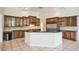 Spacious kitchen featuring island seating, stainless appliances, and custom cabinets, perfect for entertaining at 715 Hanover Ct, Lakeland, FL 33813