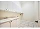 Convenient laundry room featuring white cabinets, ample counter space, and sink at 715 Hanover Ct, Lakeland, FL 33813