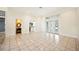 Open living room with tile flooring, French doors, and access to the kitchen and bathroom at 715 Hanover Ct, Lakeland, FL 33813