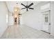 Open living room with tile flooring, modern light fixtures, and access to the patio at 715 Hanover Ct, Lakeland, FL 33813
