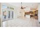 Open living area with ceiling fan, tile flooring, and connecting kitchen at 715 Hanover Ct, Lakeland, FL 33813