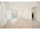 A light and airy living room with large tile flooring and french doors that bring in plenty of light at 715 Hanover Ct, Lakeland, FL 33813