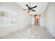 Bright living room with tile floors, bay windows, and modern ceiling fans at 715 Hanover Ct, Lakeland, FL 33813