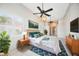 A bright main bedroom boasts two ceiling fans, natural light, and a king bed at 715 Hanover Ct, Lakeland, FL 33813